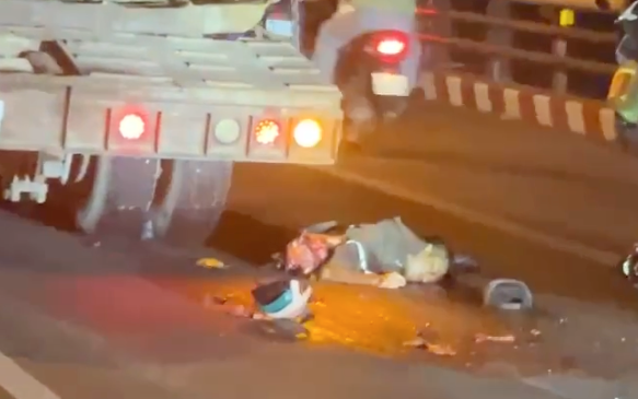 Aftermath of a traffic accident between a motorcycle and a truck