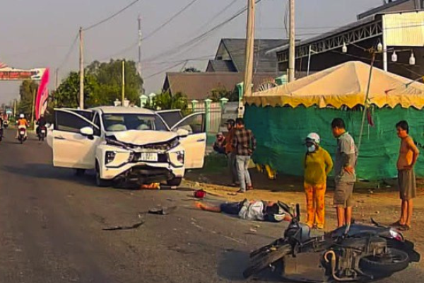 A car loses control and hits a motorbike going the other way