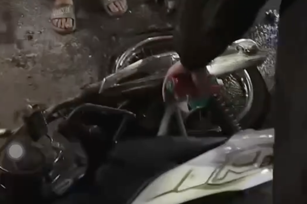 A motorcyclist slides and collides head-to-head with a car