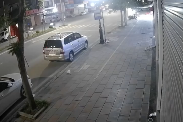 A speeding motorbike drives with its eyes closed and does not see the parked truck